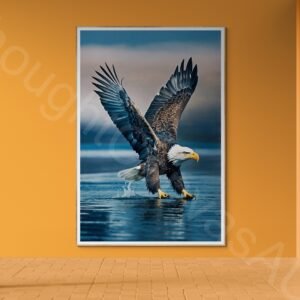 High-resolution photograph of a majestic bald eagle in flight with wings fully extended against a blurred blue background. Detailed view of the white head, dark brown feathers, and sharp yellow beak in dynamic mid-air motion.